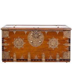 an ornate wooden box with metal decorations on it