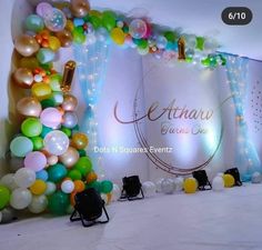 balloons and streamers decorate the backdrop for an event