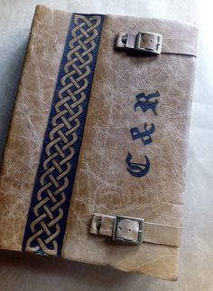 an old book with a blue and white design on the cover is sitting on a table