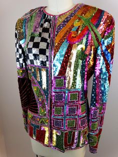 "This is a GORGEOUS vintage couture piece from Naeem Khan RIAZEE! It's fully and heavily embellished with bright sequins and glass beading. The details are AMAZING! It's in perfect condition! There are a total of 10 closures. Measurements are taken with all intact. Measurements: Bust - 34/36\" Waist - 30\" Shoulders - 18\" (hem to hem) Sleeves - 24\" Top to Bottom Length - 25\" Tag Size - Medium All of my items come from a smoke-free and pet-free home. If you have any questions, please don't hes Trophy Jacket, Digital Dress, Checkered Jacket, Beaded Jacket, Naeem Khan, Sequin Jacket, Retro Rainbow, Vintage Couture, Cape Dress