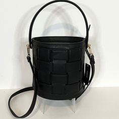 Here, The Alfani Bucket Top Handle Satchel With Adjustable Straps In New Condition With Original Tags Attached. Nwt $79.50 Black Color Faux Leather Shell With Woven Patterned Details. Bucket Styled Handbag Can Be Worn As A Top Handle Satchel Or Crossbody Messenger Handbag. Top Zip Closure With A Spacious Interior. Unique Styled Purse Is Suitable For Everyday Casual Look Or Evening Wear. Cute Purse Is A Great Statement Piece All By Itself. Approximately 8 1/2"L X 8"H X 6"W In Size With Detachable Formal Black Bucket-shape Shoulder Bag, Black Formal Bucket Shape Shoulder Bag, Formal Black Bucket Shape Shoulder Bag, Black Bucket-shaped Formal Bag, Black Faux Leather Crossbody Bucket Bag, Black Bucket Bag For Formal Occasions, Black Crossbody Bucket Bag For Fall, Black Faux Leather Bucket Bag With Adjustable Strap, Fall Faux Leather Bucket Bag