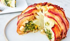 a bacon and broccoli pizza cut in half on a plate with a fork