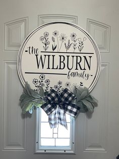 a white door with a sign that says the wilburn family