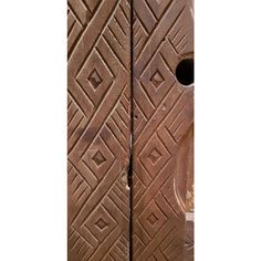 an intricately carved wooden door in the shape of a square and rectangle pattern