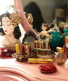 there is a vanity with many different items on the table and in front of it