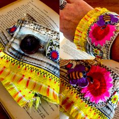 a woman's hand is holding an open book with colorful fabric and buttons on it