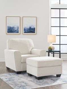 a living room with a chair and ottoman