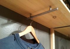 a t - shirt is hanging on a clothes rack