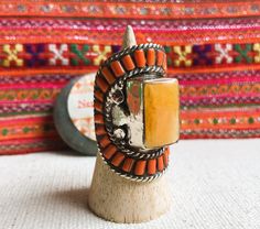 This is a Magnificent Tibetan ethnic ring, it was designed on a model of old traditional Tibetan jewelry. It is entirely handmade. This is a rare piece (limited quantity). It is made of Tibetan silver inlaid with coral and amber resin. It is very bright. This is a very large ring. Length of the ring: 4.2 cm Width of the ring: 2.5 cm Ring weight: 34 grams Does not contain nickel, lead or cadmium. It will be shipped in a small pouch. Shipping will be fast and careful. Visit the NEPALMASHOP.FR stor Amber Resin, Tibetan Jewelry, Small Pouch, Large Ring, Small Pouches, Multi Stone Ring, Ethnic Jewelry, Multi Stone, Tibet