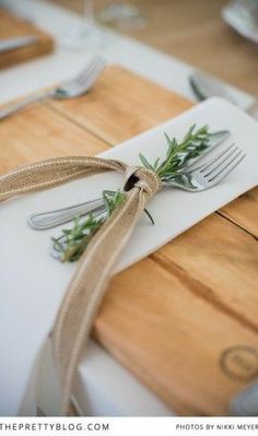 a place setting with silverware and napkins