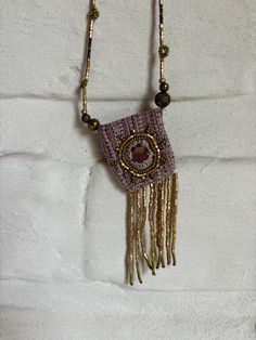 a beaded purse hanging on a wall