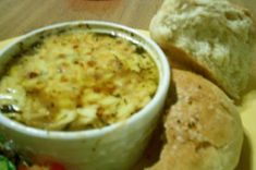 a bowl of soup and some bread on a plate