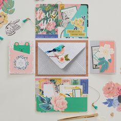 several different types of greeting cards and envelopes on a table with scissors, paper clips, and other crafting supplies