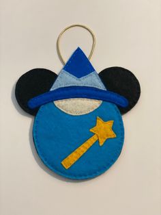 a mickey mouse ornament with a hat and star on it's head