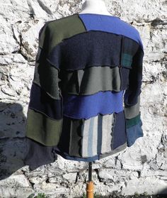 Unique patchwork jumper / sweater in blues, greens and tartan.  Made from medium weight knits, the patches are  100% wool, and of super quality.  Sleeves may be worn long, or folded back.The stitching is in purple for definition using an overlocker / serger.  Looks great on, and is both flattering as well as textural.  Size  LFlat Measurements ; Chest                              46 inches / 117 cm  Back Length                    25 inches / 63 cm   Sleeve ( from neckline )  30 inches / 76 cmMac Blue Patchwork Sweater For Winter, Blue Patchwork Sweater For Fall, Blue Patchwork Crew Neck Sweater, Multicolor Wool Sweater With Patchwork, Multicolor Wool Patchwork Sweater, Blue Wool Long Sleeve Tops, Fitted Patchwork Sweater For Layering, Winter Blue Patchwork Top, Blue Patchwork Top For Winter