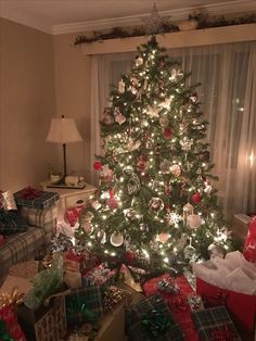 a decorated christmas tree with presents under it