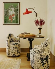 a living room filled with furniture and a chess board on top of a wooden table