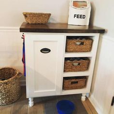 a white cabinet with baskets on top of it