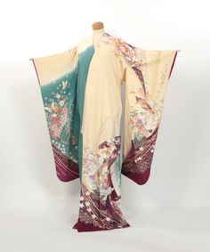 This elegant vintage Furisode kimono, crafted from 100% silk, features a serene beige fabric with beautiful gradation dyeing, showcasing graceful cranes and delicate flowers.  The unique use of color adds to its allure, making it a captivating piece for any collection.  In Japanese culture, cranes symbolize longevity and good fortune, while flowers represent beauty and the cycle of life.  Although there are noticeable stains around the collar and waist, as well as faint spots in other areas, these imperfections do not detract from its charm.  Ideal for craft projects or as a decorative piece to bring a touch of traditional Japanese elegance to your space. Size (Furisode) Mitake (A): 157.5cm Yuki(B): 66cm Sodetake (C): 103cm Maehaba(G): 23.5cm Ushirohaba(H): 29.5cm *Please refer to the illu Japanese Elegance, Flowers Represent, Japanese Traditional Clothes, Furisode Kimono, Kimono Vintage, Traditional Kimono, Cycle Of Life, Kny Oc, Indigenous Culture