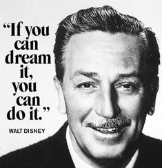 a man in a suit and tie with a quote from walt disney on the wall behind him