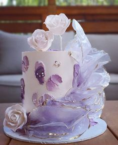 a white and purple cake with flowers on it