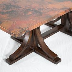 an old table with rusted metal top and wooden legs on a white background,