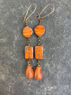 "Orange Wire Wrapped Earrings   Bohemian Earrings     Czech Glass Beads Outrageous Orange Earrings: Chunky orange  Czech glass  flat coin beads are wire wrapped using Vintaj brass parawire to orange etched tablet Czech glass beads and orange \"sea glass*\" Czech glass teardrops. Beads dangle from Vintaj antiqued brass  kidney ear wires for added security.   *\"Sea Glass\" is made from cultured sea glass and has been tumbled and smoothed using sand to emulate real sea glass.  I support Etsy selle Orange Earrings, Earrings Bohemian, Wire Wrapped Earrings, Bohemian Earrings, Lovely Earrings, Glass Earrings, Beaded Dangles, Bohemian Jewelry, Czech Glass Beads