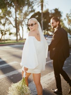 a man and woman walking down the street