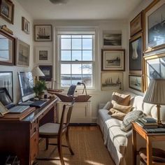 a living room filled with furniture and lots of pictures on the wall next to a window