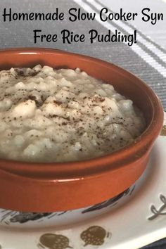 a bowl filled with food sitting on top of a white and brown plate next to a cup