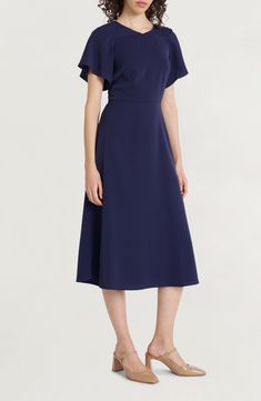 A desk-to-dinner dress is rendered in classic navy and fixed with fluttering sleeves for a dash of added charm. 47 1/2" length Hidden back-zip closure Jewel neck Short sleeves 100% polyester Machine wash, tumble dry Imported Satin Dress Short Sleeve, Evening Midi Dress, Grey Midi Dress, Illusion Dress, Flounced Dress, Empire Dress, Maggy London, Dinner Dress, Pink Midi Dress