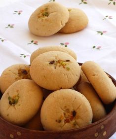 a wooden bowl filled with cookies on top of a table