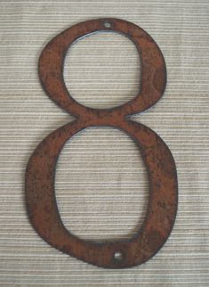 the number eight is made out of rusty metal