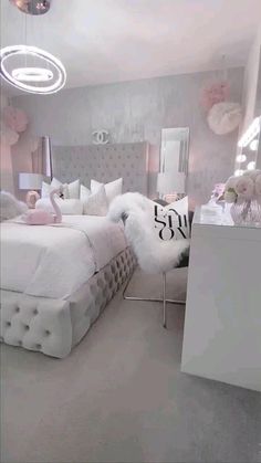 a white bed sitting in a bedroom next to a mirror