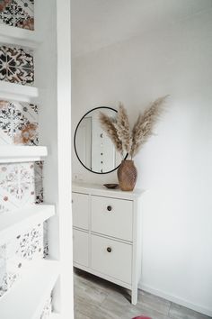 a white dresser and mirror in a room