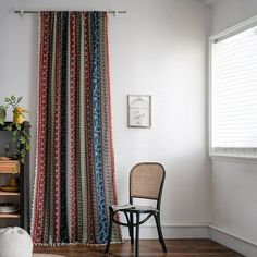 a chair sitting next to a window in a room