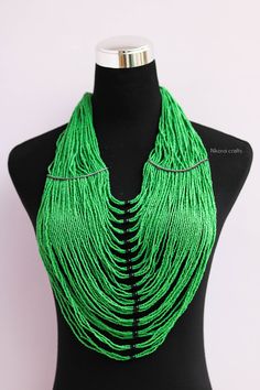 African beaded necklaces, Beaded necklaces for women, African women jewelry, Beaded fringe necklace, Christmas gift for her, Moms gift An elegant necklace that can compliments any outfit. Handmade by the Maasai women in Kenya using fine beads. One size fits all. Color: Green Necklace length: 17 inches 3-5 days delivery via DHL Express. Pay shipping fee for the first item only and additional items ship for FREE. To view more items in our shop, kindly click here: https://www.etsy.com/shop/NkoroiCr Green Round Beads Bib Necklace As Gift, Green Bib Necklace With Round Beads For Gift, Necklace Snake, North Star Necklace, Face Jewellery, Fringe Necklace, Christmas Gift For Her, Necklace Necklace, Beaded Fringe