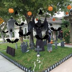 a yard decorated for halloween with pumpkins and decorations