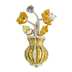 This whimsical floral design pin features natural colorless and fancy colored diamonds set in platinum and 18kt yellow gold. This lovely pin showcases fancy yellow, orange, and gray fancy shape diamonds in a colorless and fancy yellow diamond pave vase. The heart shape diamond is a GIA-certified 0.92ct Natural Fancy Vivid Orange-Yellow. This classic pin from the 20th century is a wonderful addition to any woman's jewelry box. Colored Diamond Jewelry, Fancy Yellow Diamond, Floral Brooch, Antique Brooches, Diamond Brooch, Heart Shaped Diamond, Fancy Diamonds, Fancy Color Diamonds, Gold Floral