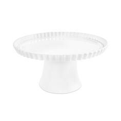 a white cake plate sitting on top of a table