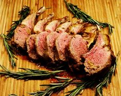 sliced meat with herbs on a cutting board