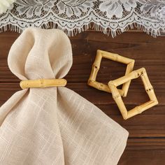 two pieces of bamboo sitting on top of a wooden table next to a cloth bag