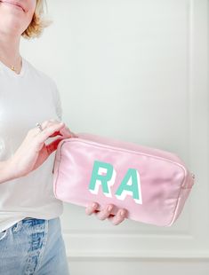 "You can never have too many monogrammed bags! The sweetest pink nylon zipper bag is perfect to carry your lipglosses, sunglasses, vitamins, essential oils. Use it to store and carry makeup, a coin purse, school supplies and more! We love these for birthday gifts and bachelorette party gifts and bridesmaid gift.  A great cosmetic bag for travel, makeup artists, teens, and school organization. D E T A I L S * 10\" x 5\" x 3\"  * 3\" gusseted bottom F A B R I C  * nylon * wipeable interior and ext Personalized Pouch Cosmetic Bag For Daily Use, Personalized Pouch Cosmetic Bag, Personalized Cosmetic Pouch Bag, Personalized Zipper Pouch Cosmetic Bag, Customizable Everyday Rectangular Cosmetic Bag, Customizable Rectangular Cosmetic Bag, Personalized Rectangular Travel Cosmetic Bag, Custom Name Pink Travel Bag, Monogram Cosmetic Bag