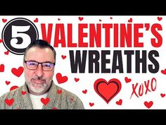 a man with glasses is standing in front of a sign that says valentine's wreaths