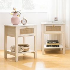 two white nightstands with baskets and books on them