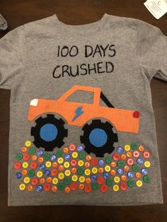 a t - shirt that says, 100 days crushed with a monster truck on it