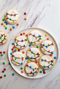 cookies decorated with icing and colored candy on a plate