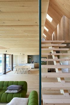 a living room filled with furniture and wooden walls