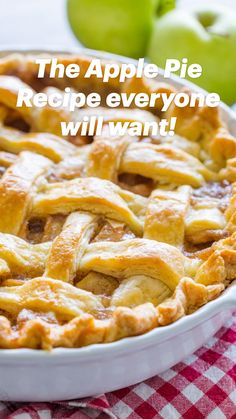 an apple pie sitting on top of a red and white checkered table cloth