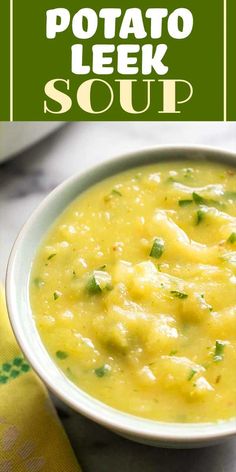 a white bowl filled with potato leek soup on top of a green napkin next to a